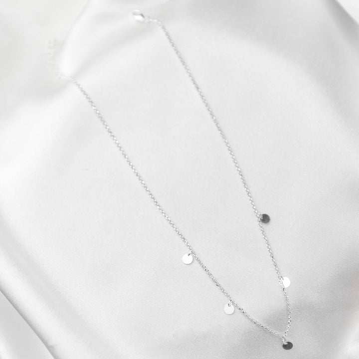 waterproof multi disc necklace on white sheet