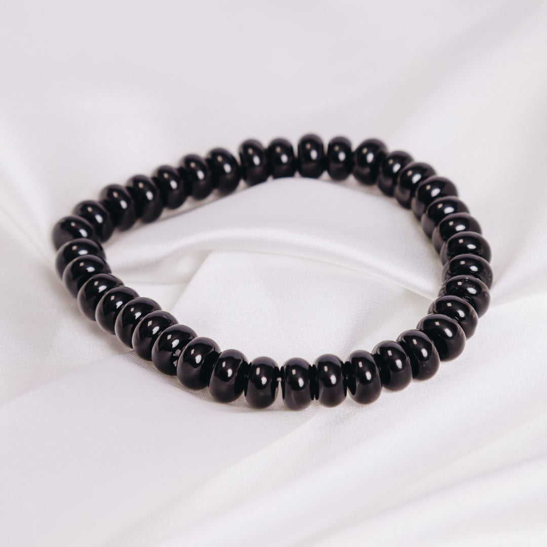 black onyx smooth button bracelet on a white cloth