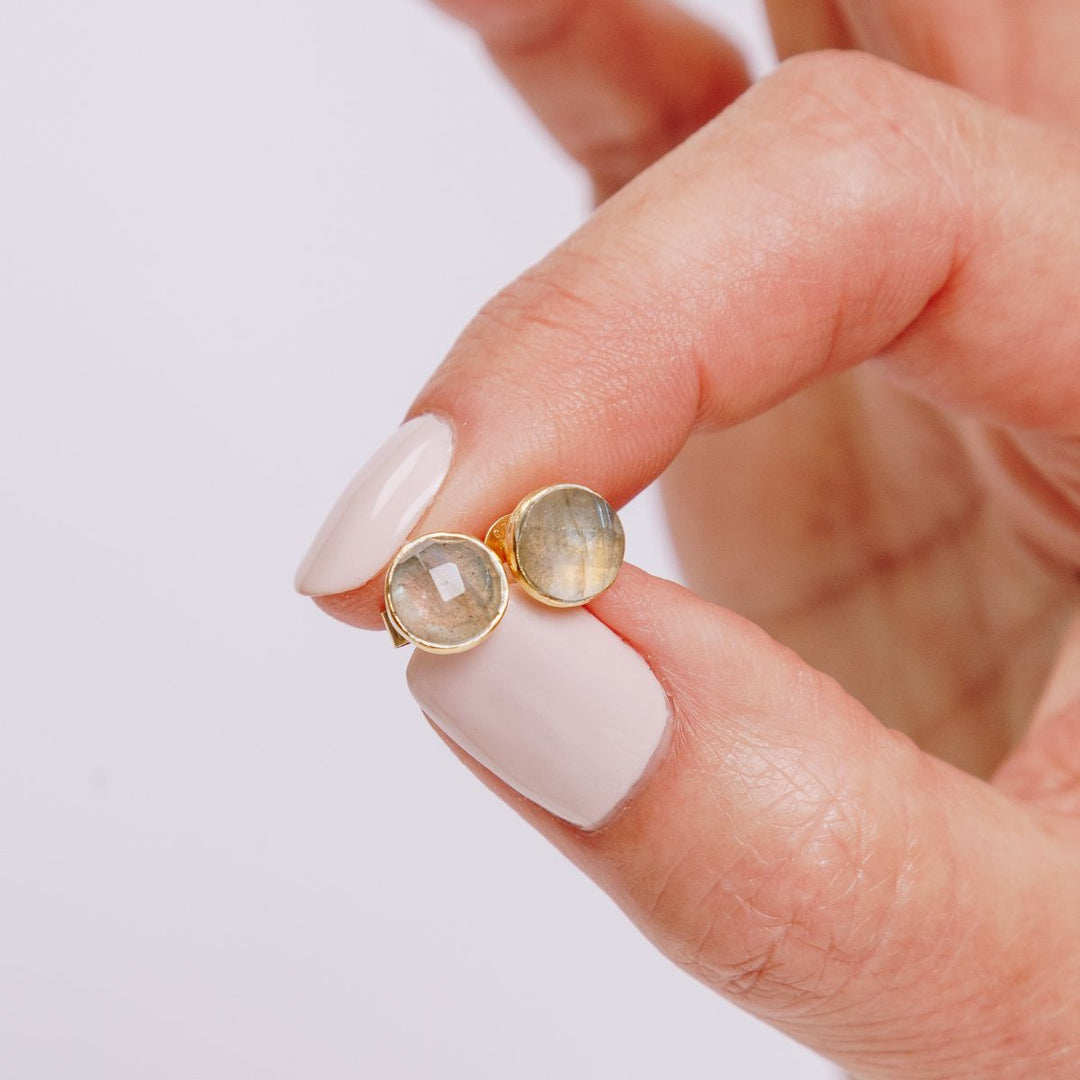 a woman holding earrings in her hand
