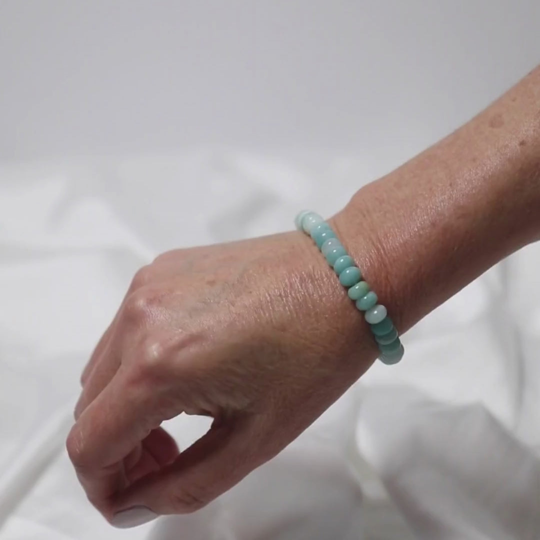 a woman wear an amazonite button bracelet on her wrist