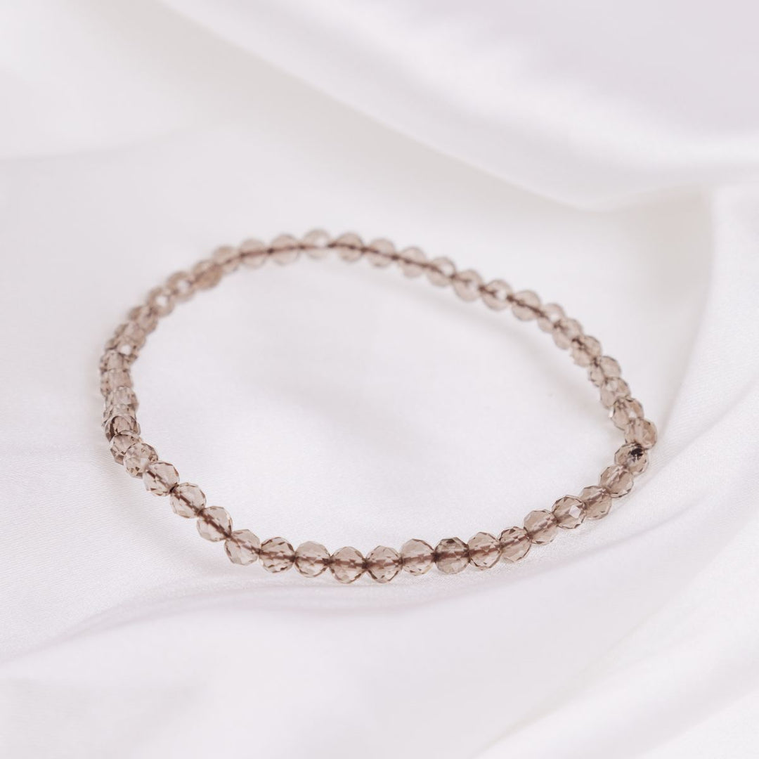 smokey quartz stone bracelet on a white cloth