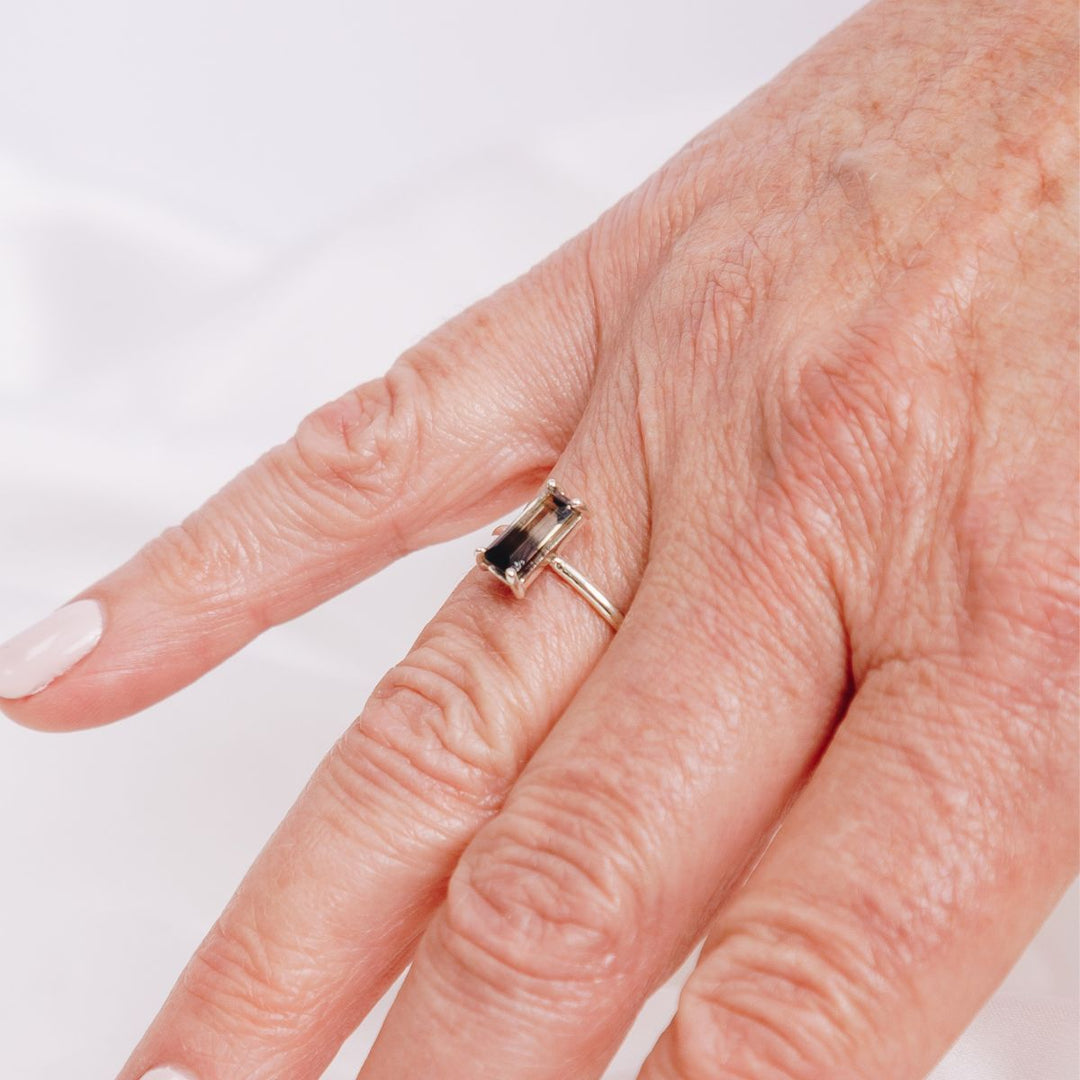 a woman wearing a very bold rectangular shaped ring on her finger
