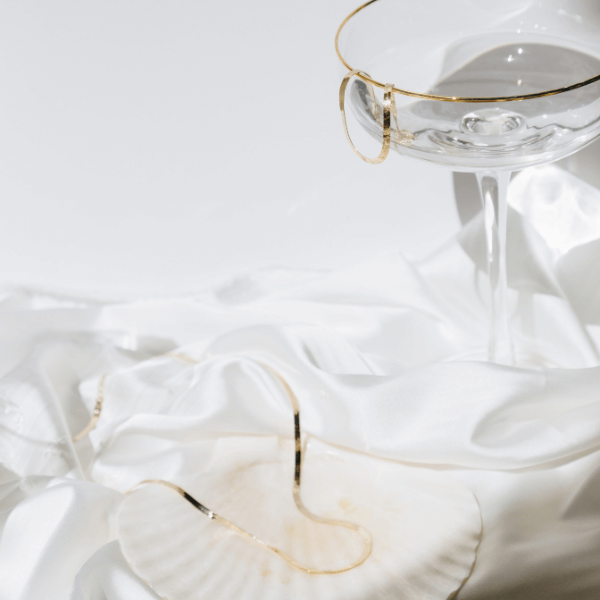 waterproof herringbone necklace hanging on champagne glass