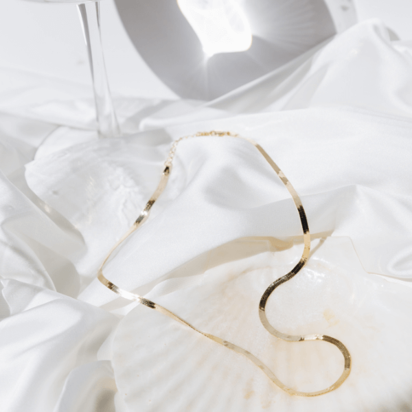 waterproof herringbone necklace on white sheet