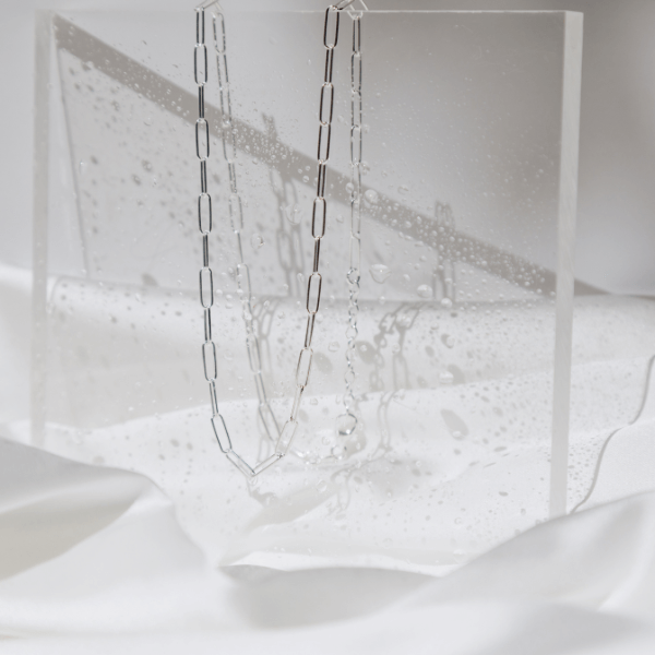 waterproof paperclip "paris" necklace on clear stand with water droplets