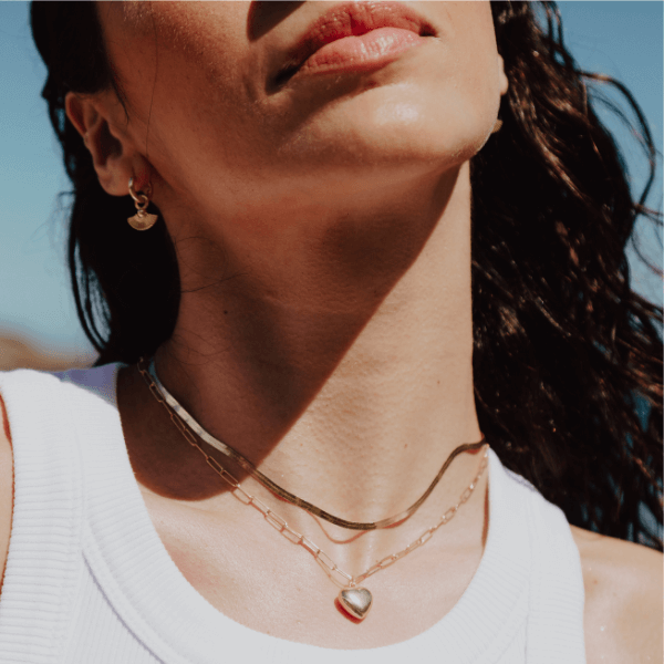 waterproof herringbone necklace layered on model