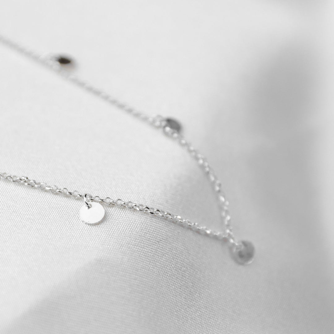 waterproof multi disc necklace on white sheet