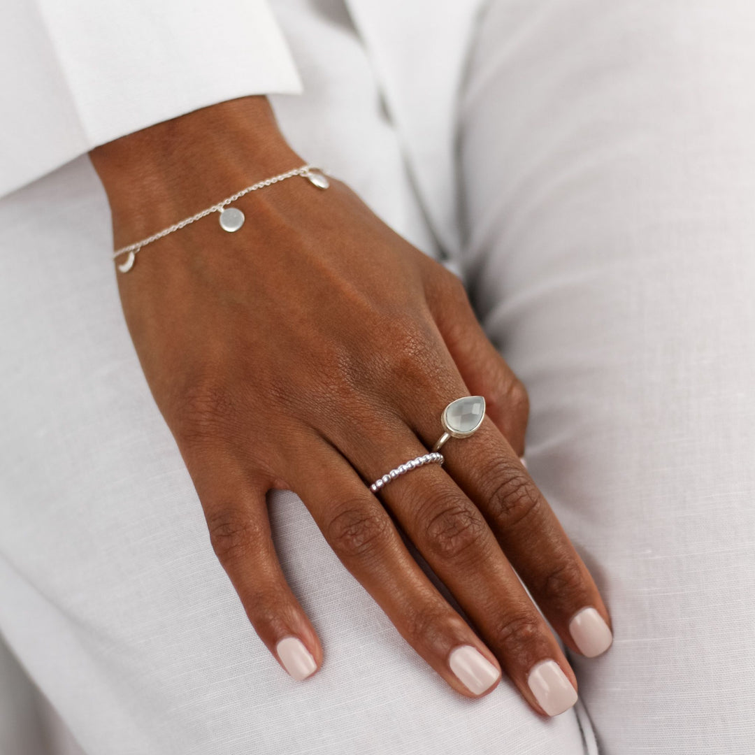 Waterproof Multi Disc Bracelet on models hand with other jewels