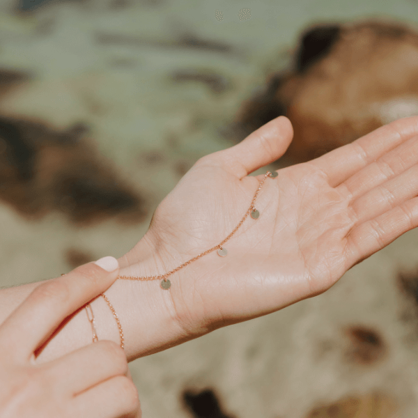 waterproof multi disc necklace on model hand 