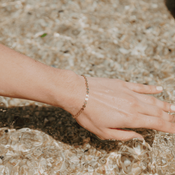 Waterproof Sequin Bracelet on model hand over water
