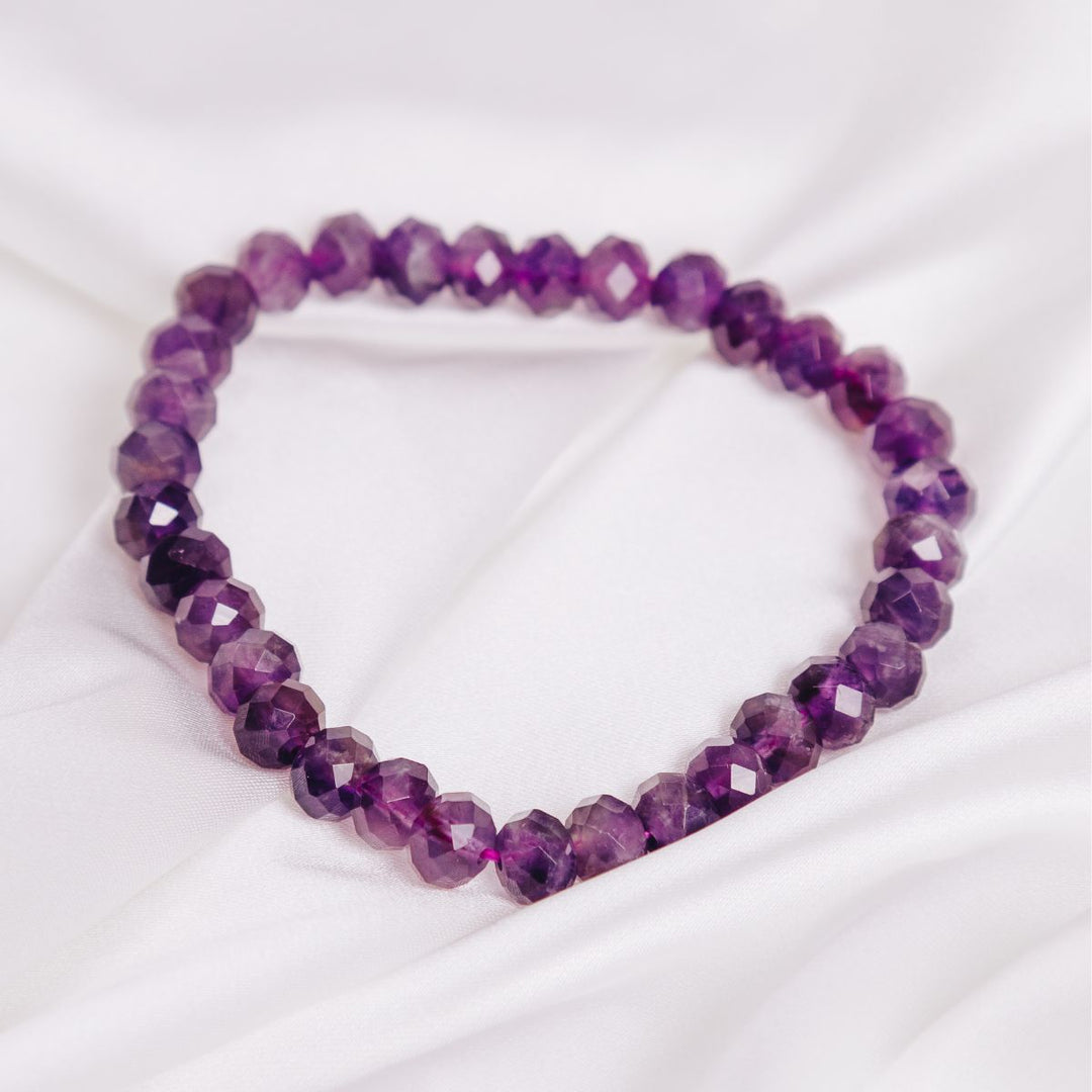 facetted amethyst button bracelet on a white cloth