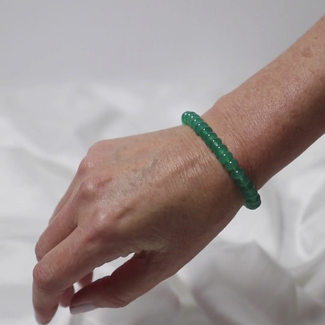 a woman wearing  green onyx button bracelet on her wrist 