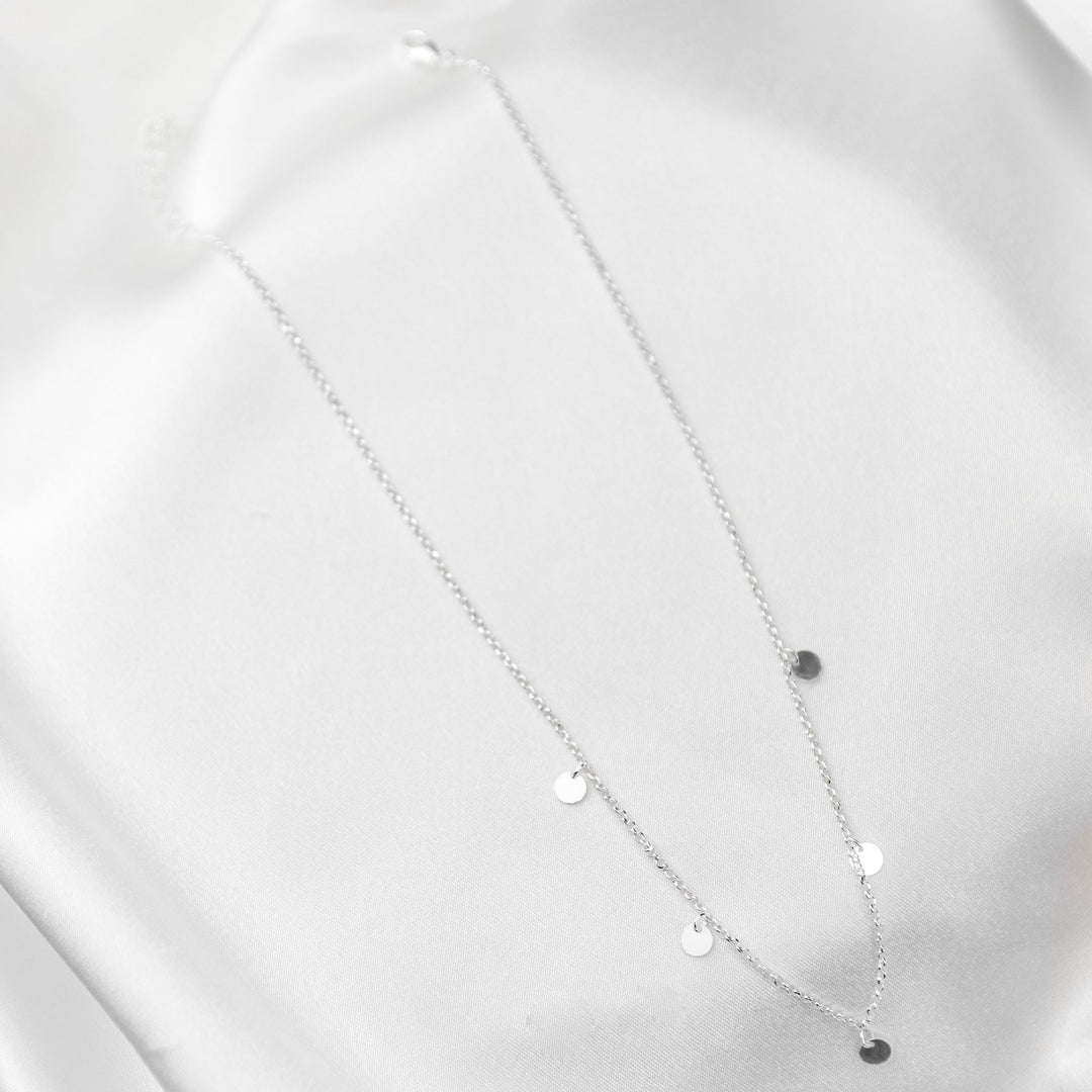 waterproof multi disc necklace on white sheet